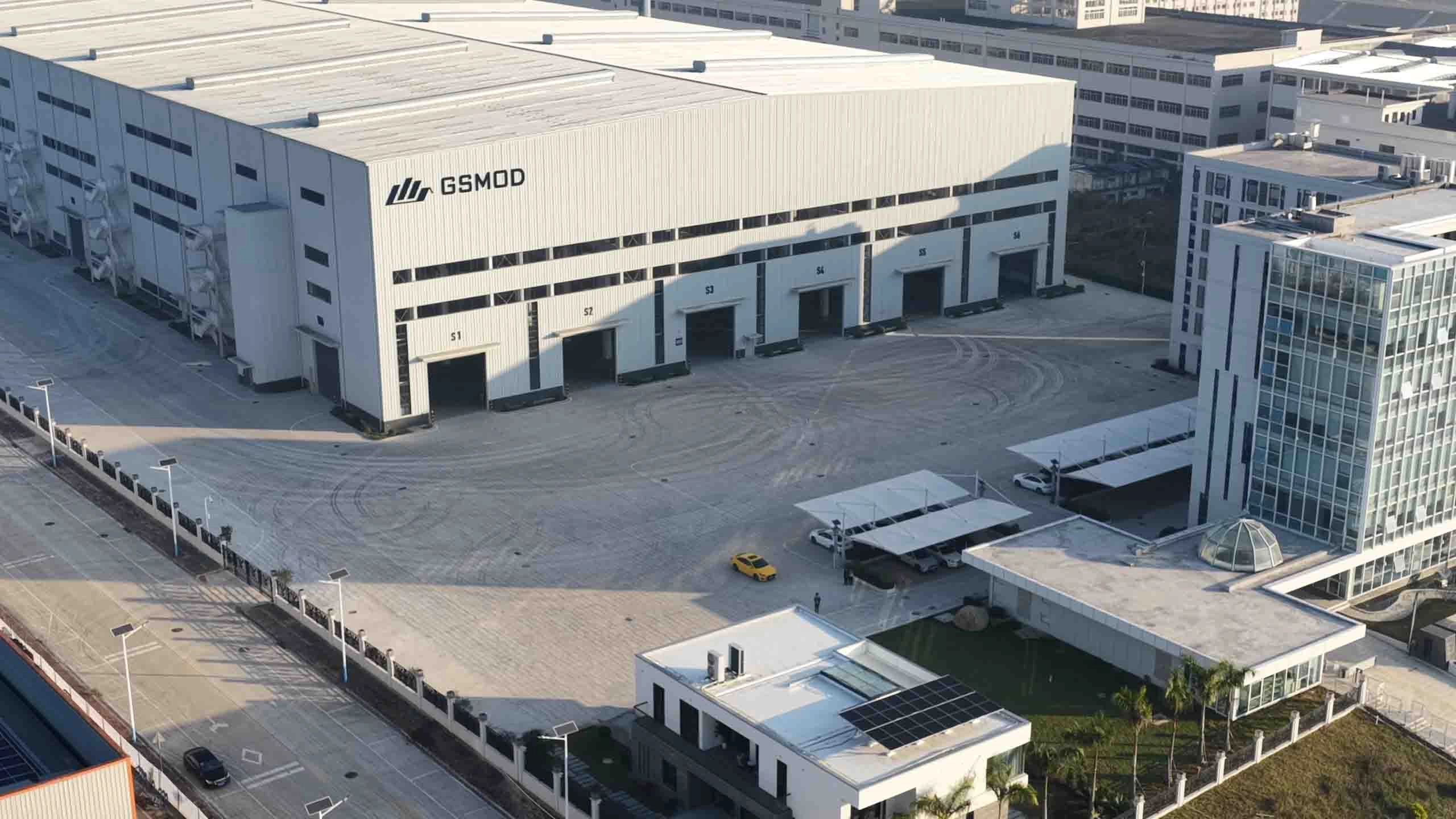 GS Housing modular construction factory workshop showing prefabricated container house production line with steel structure assembly