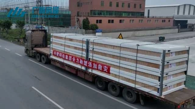 flatbed truck transporting emergency housing units for overseas aid shipment flatbed truck transporting emergency housing units for overseas aid shipment
