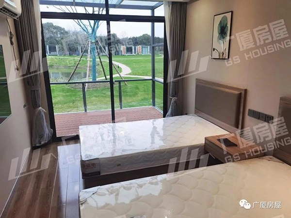 interior room of resort accommodation with large window and natural daylight