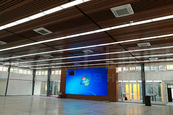large exhibition hall interior with display screen and wood ceiling panels large exhibition hall interior with display screen and wood ceiling panels