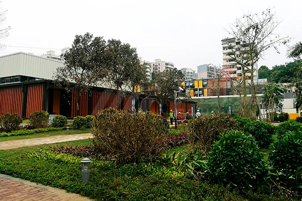 modular building exterior surrounded by trees, shrubs and garden landscape modular building exterior surrounded by trees, shrubs and garden landscape