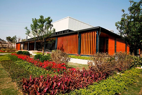 modular office building with vertical facade panels and green landscape modular office building with vertical facade panels and green landscape