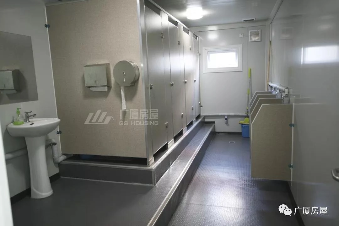 prefab bathroom unit with toilet partitions, wash basin and clean interior prefab bathroom unit with toilet partitions, wash basin and clean interior