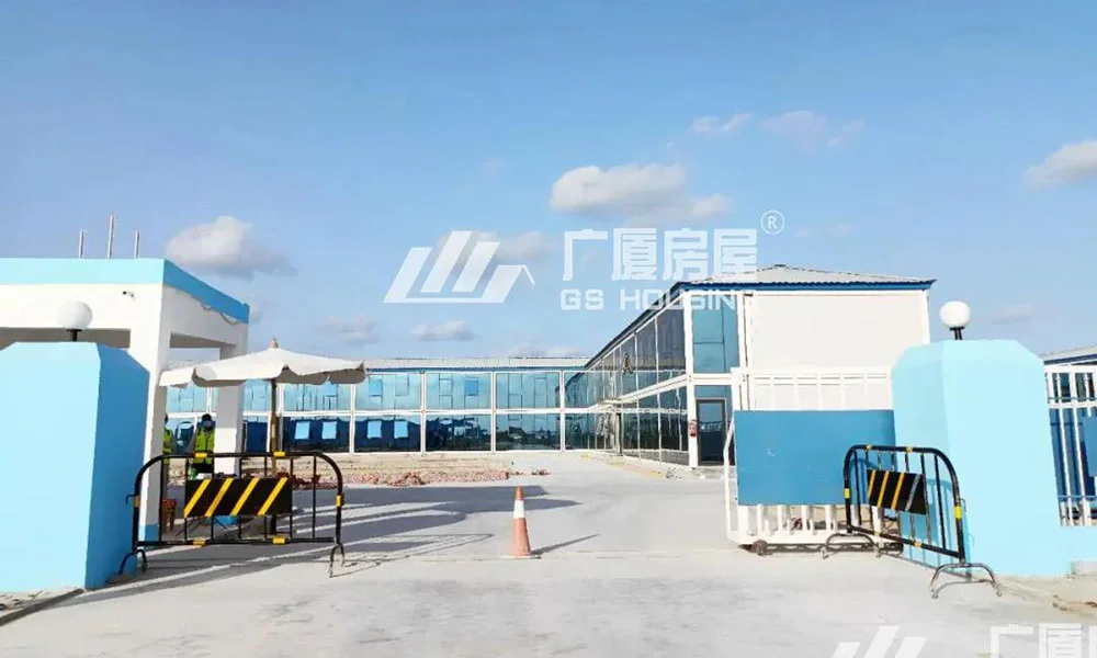 prefab container house camp entrance with blue and white modular buildings