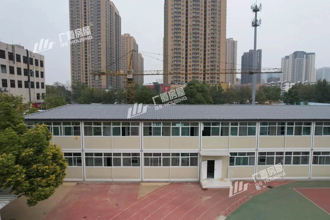 primary school campus building with modular classroom blocks and urban surroundings