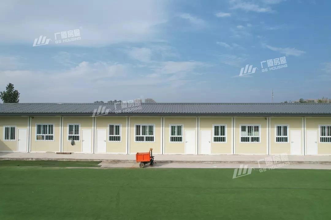 primary school sports ground and modular classroom buildings in organized layout