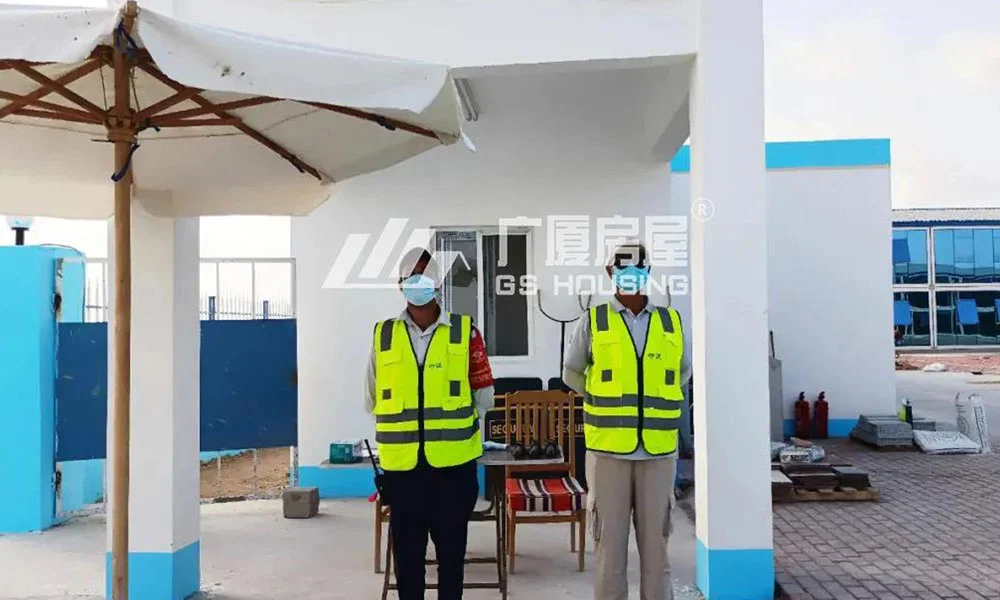 security personnel standing outside prefab container house camp