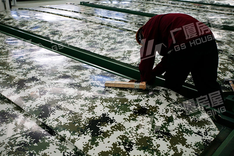 worker sealing camouflage panel for flat pack container house
