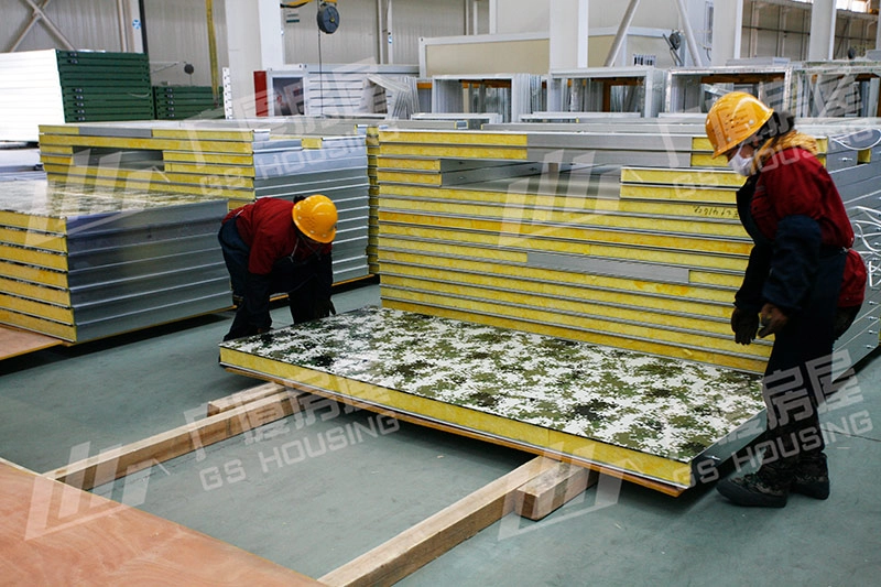 workers assembling insulated panels for camouflage container house workers assembling insulated panels for camouflage container house