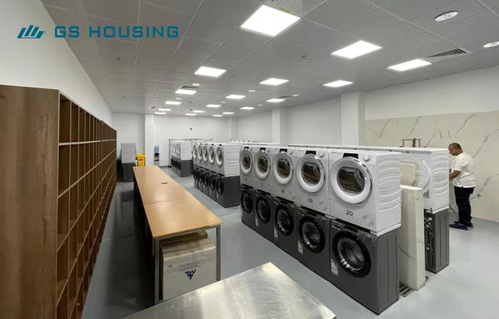 labor camp container laundry room interior with washing machines
