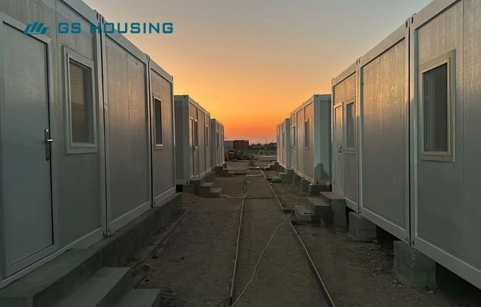modular camp accommodation units arranged along temporary site walkway