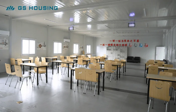 prefab construction camp dining hall interior with tables and chairs