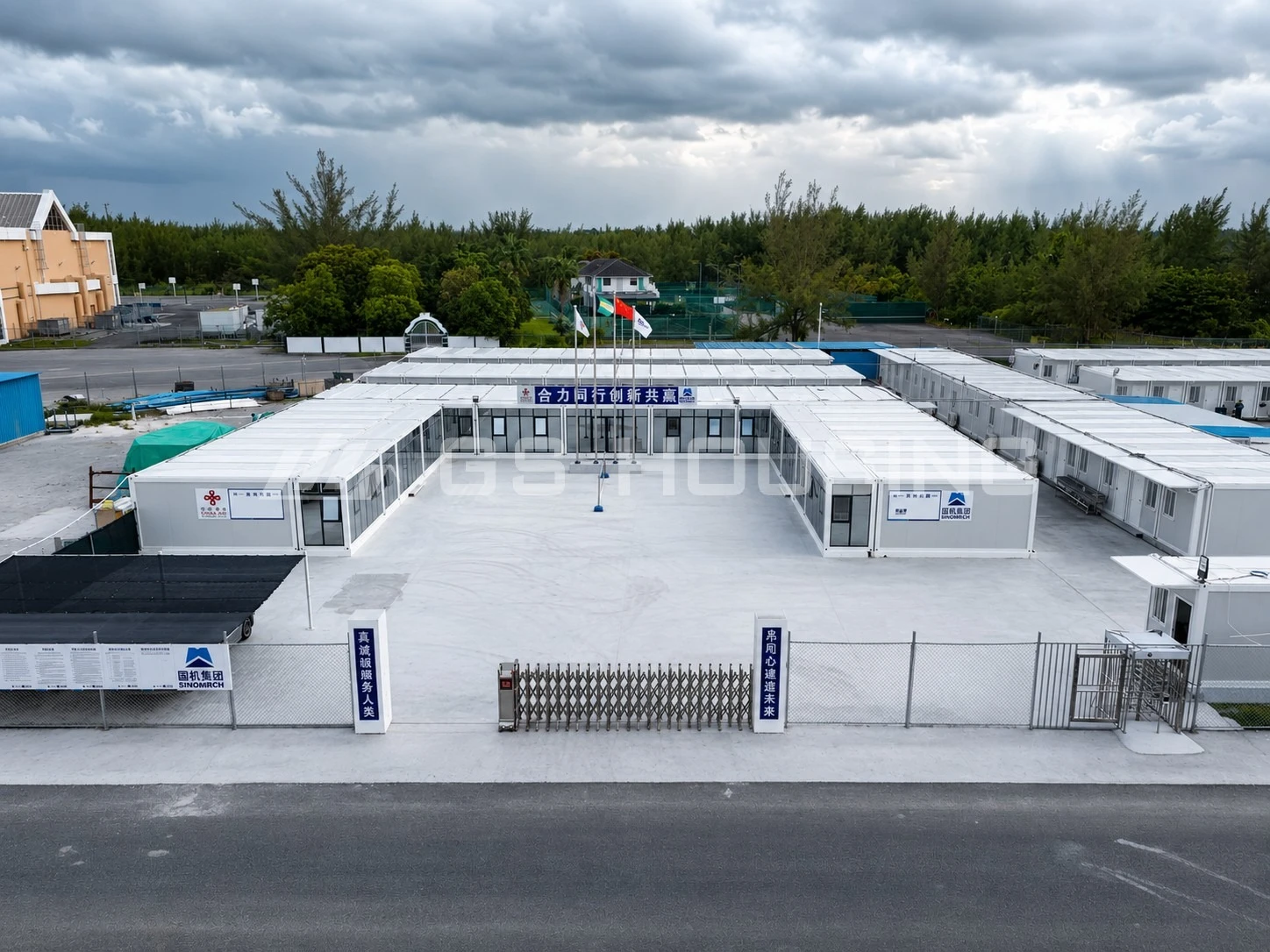 Aerial view of the 144‑unit modular site office and construction site accommodation facility for the Bahamas stadium renovation project, showing organized buildings around a central courtyard