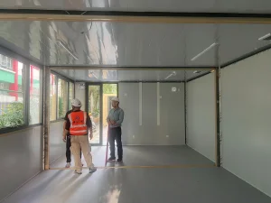 Engineering team conducting a quality inspection inside a modular classroom during on-site installation in Tai Po
