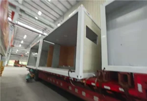 Factory-prefabricated modular toilet units being loaded and secured onto transport truck 