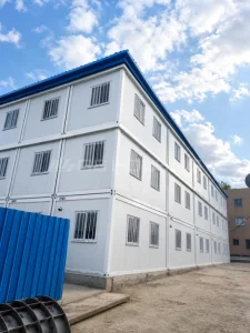 Side view of three-storey modular office building made from vertically stacked flat pack container units in Ethiopia