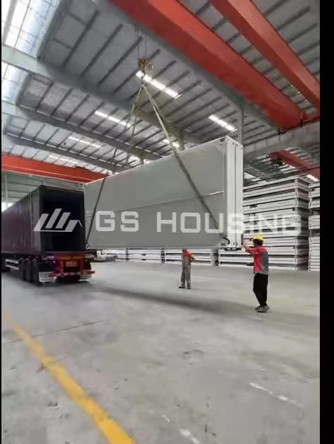 Flat-pack modular building components loaded for container shipping