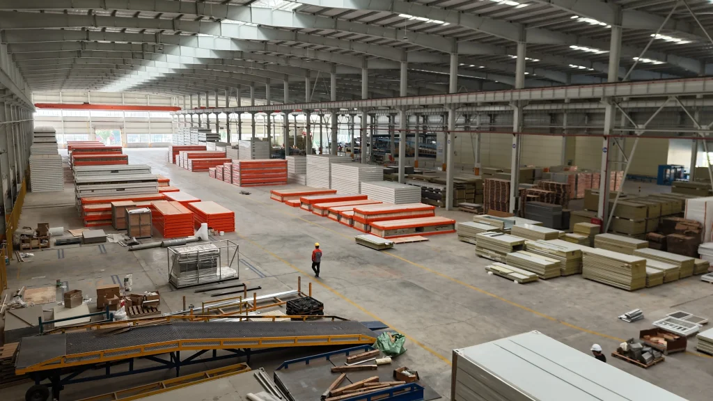 GS Housing factory interior with prefabricated wall and roof panels