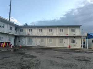  Two-storey modular site building at the Guinea Conakry Port Expansion Phase II project, with external access corridors, individual rooms and a paved working area